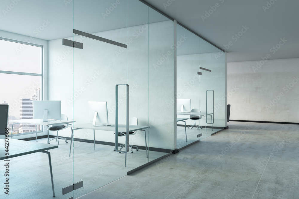 Fototapeta premium Perspective view on light interior design office cabinets with concrete floor, glass walls, modern computers on work tables and city view from big windows. 3D rendering