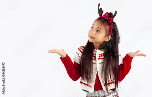 Little asian kid in red and white sweatshirt Christmas theme costume posing hand pointing choosing on white background.