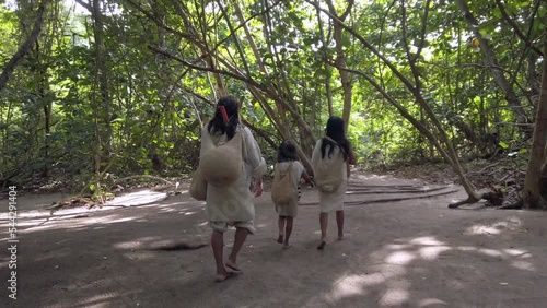 Colombia, Tayrona national park   2022 family mom dad and child of Colombian indigenous tribe people aboriginal live in the forest in Santa Marta - kogi people