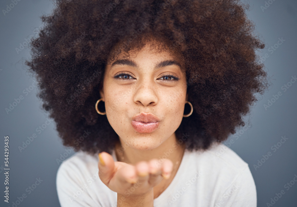 Face, portrait and woman blowing a kiss on a grey studio background being flirty and seductive. Fun, flirting and beautiful african american female kissing and being alluring and isolated on backdrop Face, portrait and woman blowing a kiss on a grey studio background being flirty and seductive. Fun, flirting and beautiful african american female kissing and being alluring and isolated on backdrop