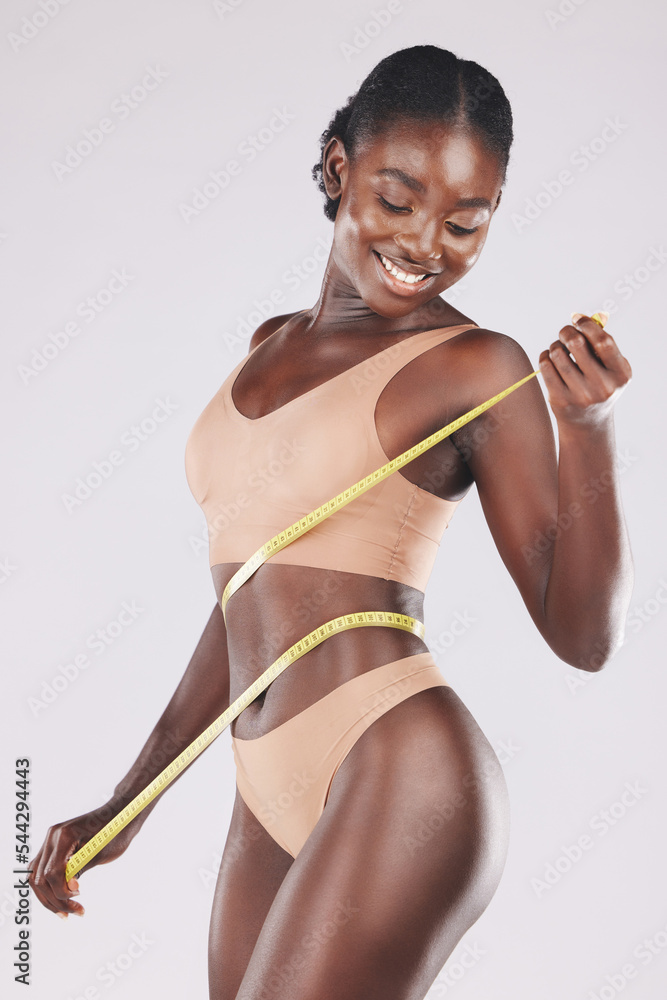 Weight loss, waist and tape measure of a black woman in studio for a slim  body