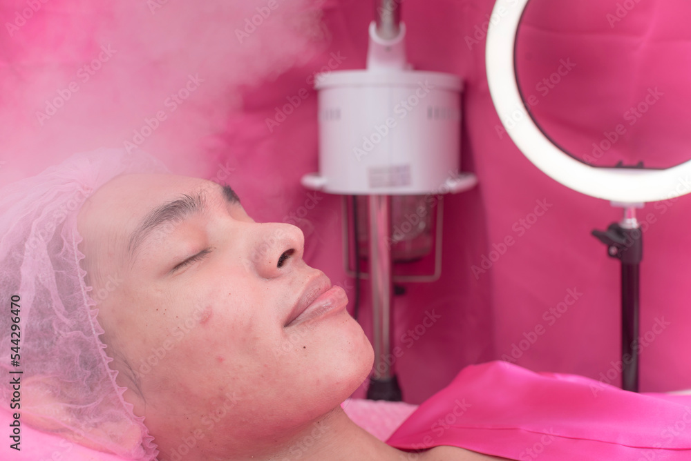 A customer undergoes a steaming treatment to open up the skin pores