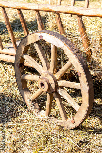 Vintage wooden carriage wheel with a rusty rim from an old cart