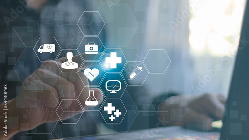 Businessman presses virtual medical healthcare icon with medical network connectivity Public health care is increasing, the growth of health insurance and life insurance businesses.