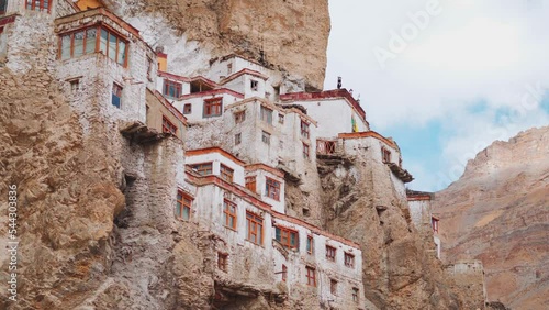 4K closeup shot of Phugtal Monastery made in a natural cave near Purne village in Zanskar, Ladakh India. Ancient monastery in a cave more than 2550 years ago in India. Monastery built inside the cave. photo