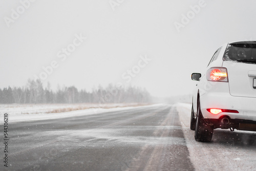 Car travel concept. Car on the empty snowy road background.