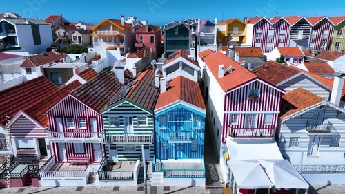 Colored houses on the beach of Costa Nova on the shore of the Ria de Aveiro on the Atlantic coast of Portugal. It belongs to the city of Ilhavo. Aerial view from a drone. Portugal. Europe