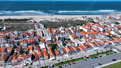 Colored houses on the beach of Costa Nova on the shore of the Ria de Aveiro on the Atlantic coast of Portugal. It belongs to the city of Ilhavo. Aerial view from a drone. Portugal. Europe