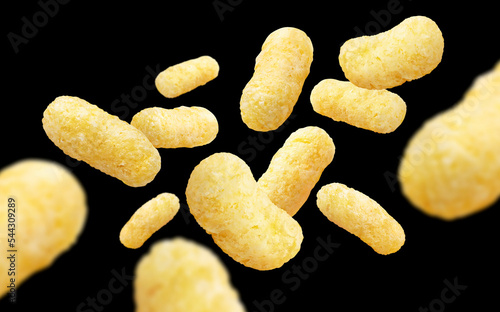 Flying corn sticks, isolated on black background photo