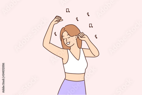 Smiling girl dancing to music 