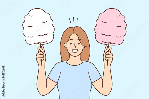 Smiling woman holding cotton candy 