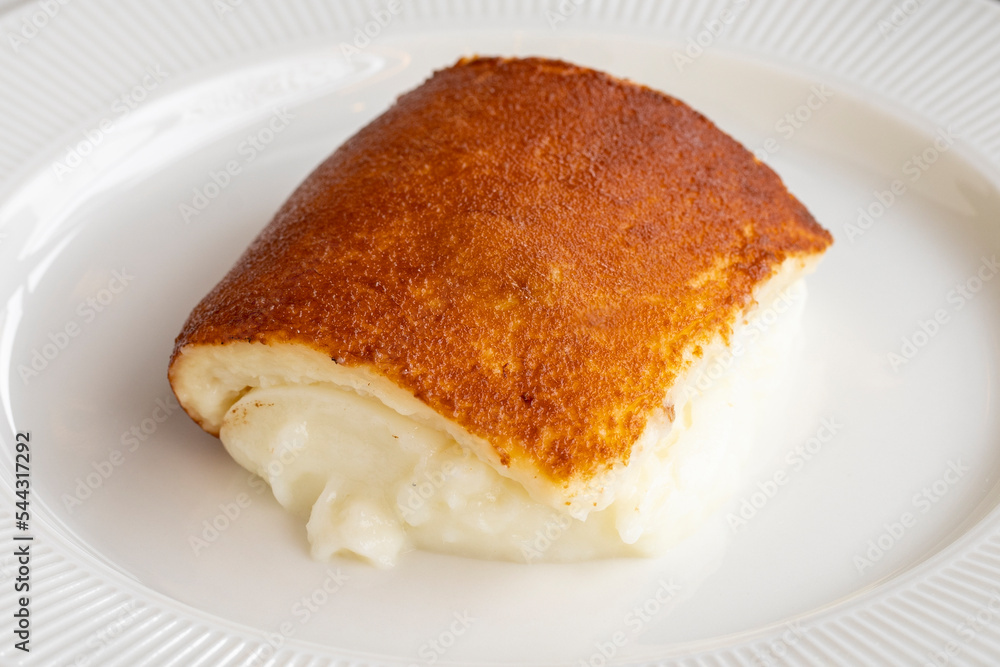 Kazandibi dessert on a dark background. Milky dessert. Traditional Turkish cuisine delicacies. close up Kazandibi dessert on a dark background. Milky dessert. Traditional Turkish cuisine delicacies. close up
