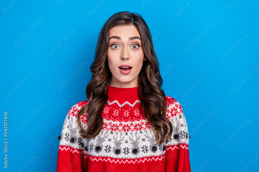 Photo of astonished pretty cute lady dressed red stylish ugly sweater impressed season low prices clothes isolated on blue color background Photo of astonished pretty cute lady dressed red stylish ugly sweater impressed season low prices clothes isolated on blue color background