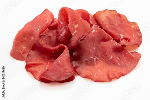 Bresaola slices isolated on white, italian dried beef salami from Valtellina photo