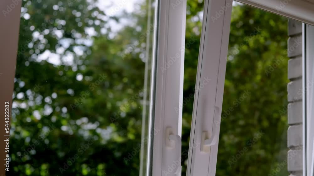 manual open white pvc plastic window at home for ventilation in good weather. manual open white pvc plastic window at home for ventilation in good weather.