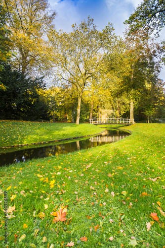 Little wooden bridge over a canal in the park in Leeuwarden, Netherlands photo