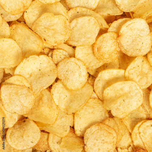 Crispy fresh potato chips, snacks background. Top view, flat lay.