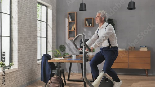 healthy lifestyle,work break,business man does physical activity exercise in office,male woker exercising on stationary bike at the workplace photo