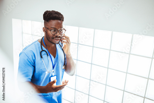 Cropped shot of a young handsome male medical practitioner working in a hospital. Healthcare is my calling. Talking to a patient about their health photo