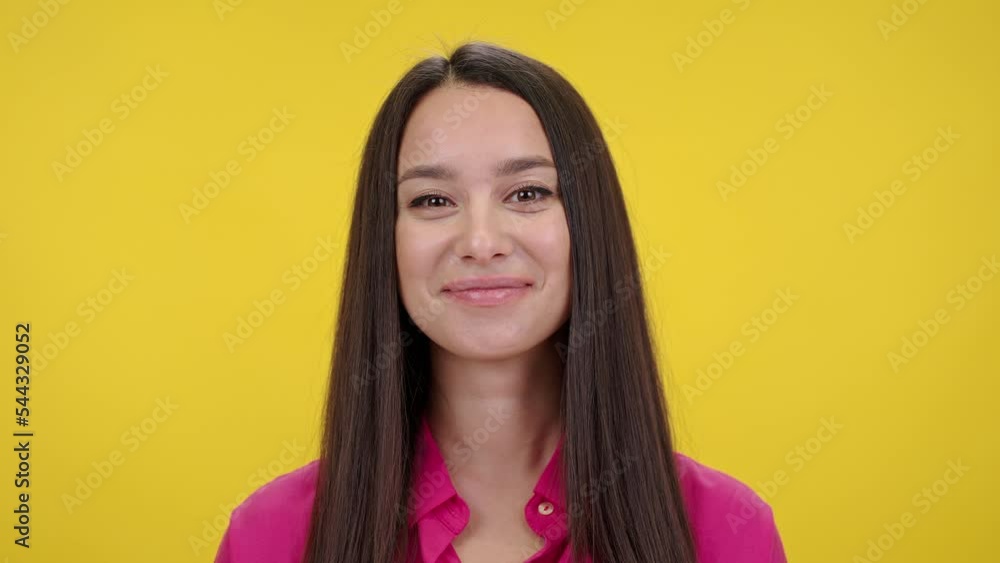 Young long-haired woman smiles sweetly looking satisfied Young long-haired woman smiles sweetly looking satisfied