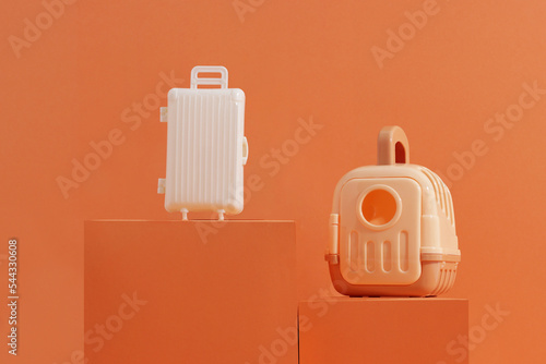 Concept travel or moving with animal, flight, safety. Plastic cage, pet carrier and suitcase on orange background (ID: 544330608)