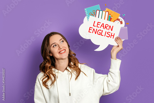 student girl holding speech bubble with text learn english and illustration isolated on lilac background photo