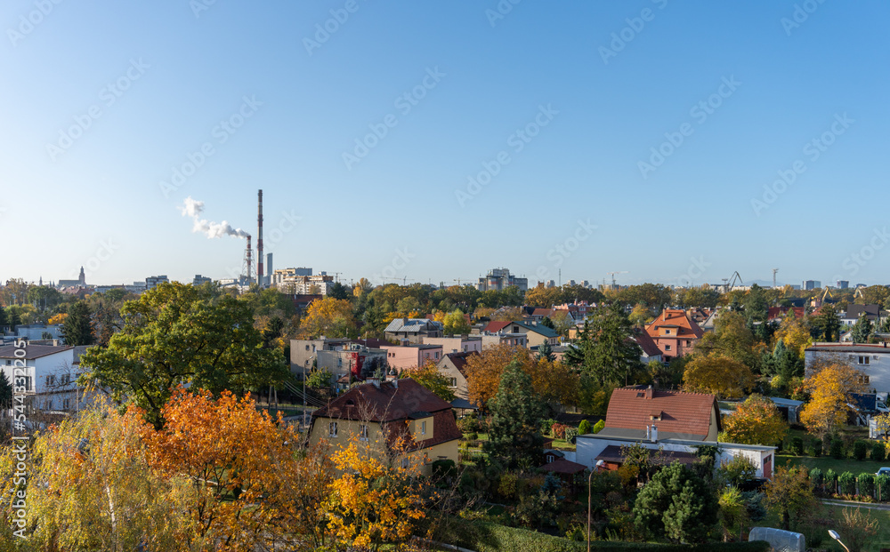 Autumn city landscape with smokey chimney in the background 