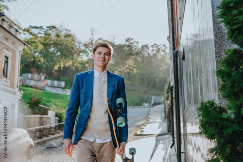 Businessman in suit using cellphone holding longboard photo