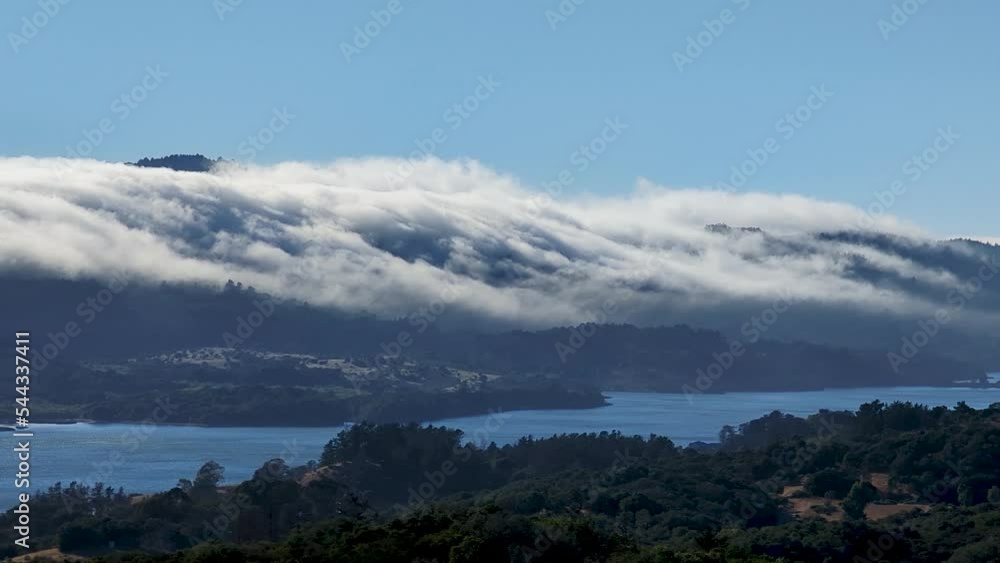 Waves of cloud flowing over the peaks of Crystal Springs Reservoir in San Mateo County, California near I-280 Waves of cloud flowing over the peaks of Crystal Springs Reservoir in San Mateo County, California near I-280