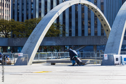 Photography A homeless person walking with their belongings in the cart across Nathan Philli