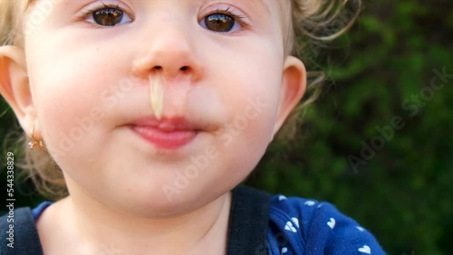 The child has snot on his face. Selective focus.