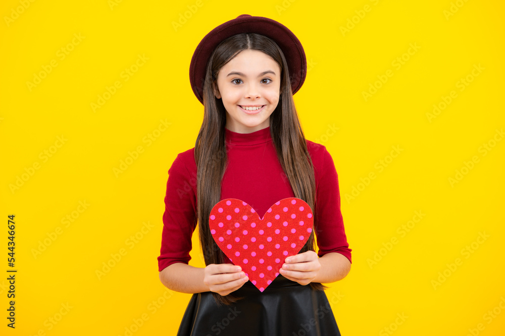 Happy teenager portrait. Young teenager child girl with heart shape. Happy Valentines Day. Love and pleasant feelings concept. Smiling girl. Happy teenager portrait. Young teenager child girl with heart shape. Happy Valentines Day. Love and pleasant feelings concept. Smiling girl.