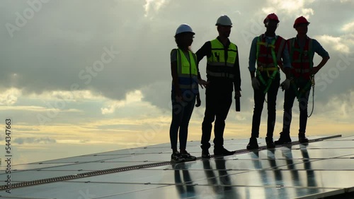 Wallpaper Mural Group professional Electrical Solar Power Engineers In Backlight Sunset. Team of industrial colleagues using tablet monitoring rows of photovoltaic solar panels. Alternative energy concept Torontodigital.ca