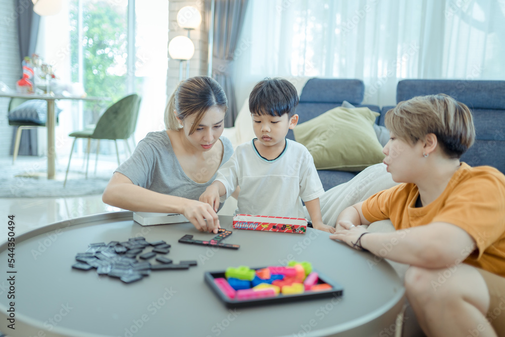 Happy lesbian multiethnic couple in love with childen at home. Family lgbt child happiness concept ,LGBT lesbian couple Moments happiness concept Happy lesbian multiethnic couple in love with childen at home. Family lgbt child happiness concept ,LGBT lesbian couple Moments happiness concept