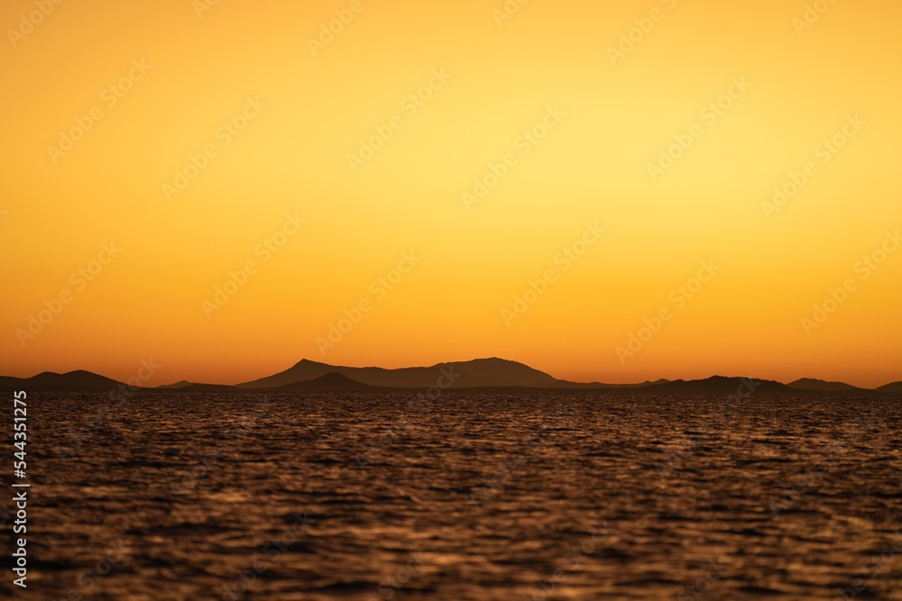 yachts and boats on the ocean in the evening