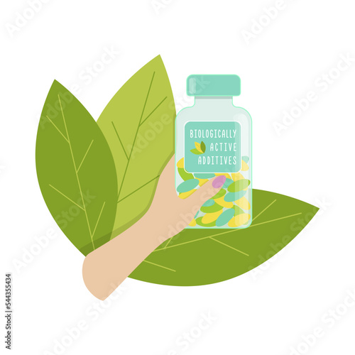 Biologically active additives female hand holds bottle with dietary supplements, with green leaves.