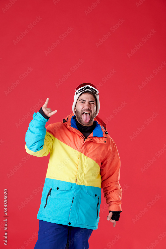 Young boy sticking out his tongue in winter clothes holding up the fingers of one hand. Young boy sticking out his tongue in winter clothes holding up the fingers of one hand.