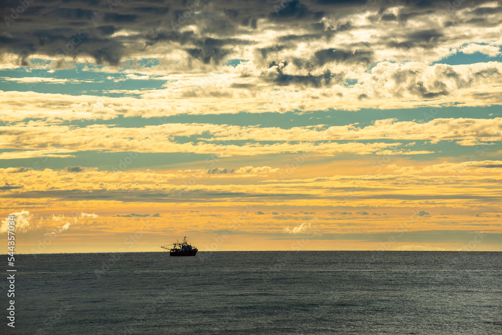 Ship in marine landscape at evening, Patagonia, Argentina.