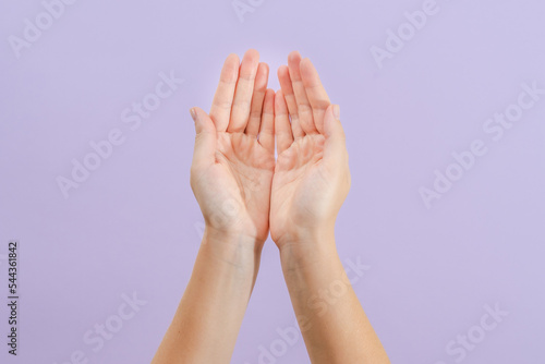 Woman's hands on lilac background. Skin care for hands, manicure and beauty treatment.