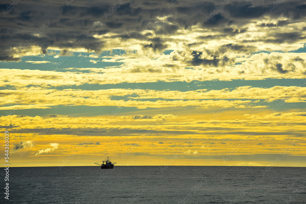 Ship in marine landscape at evening, Patagonia, Argentina.