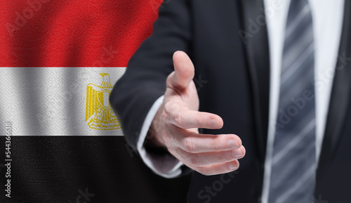 Welcome to the Egypt. Hand on Egyptian flag background. Business, politics, cooperation and travel concept