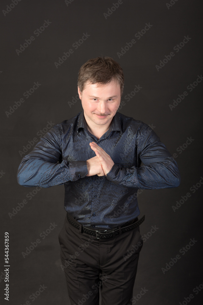 man in a shirt on a black background man in a shirt on a black background