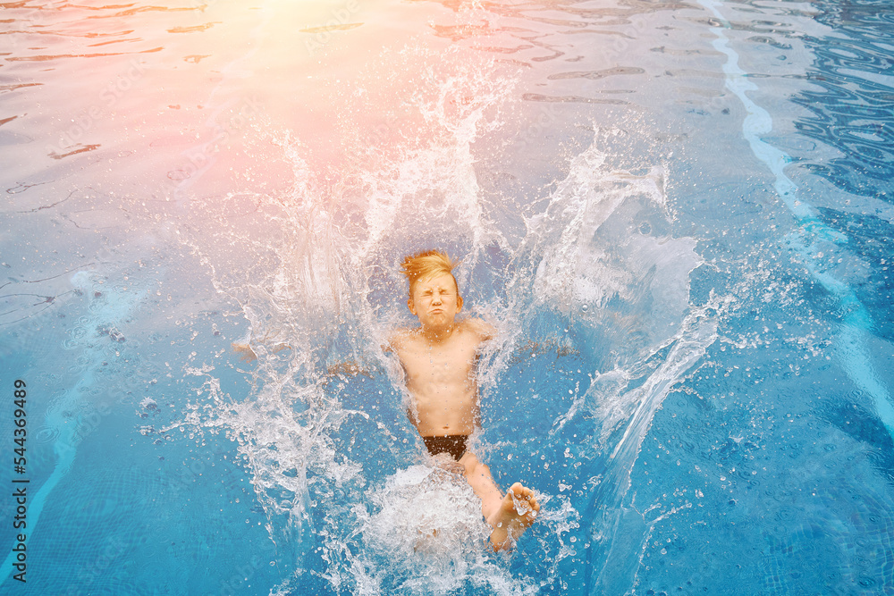Child jump, swim in the pool, sunbathes, swimming in hot summer day. Relax, Travel, Holidays, Freedom concept. 
