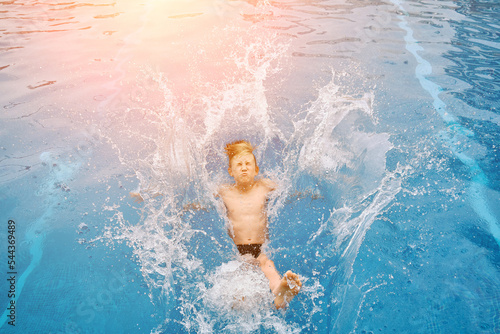 Child jump, swim in the pool, sunbathes, swimming in hot summer day. Relax, Travel, Holidays, Freedom concept. 