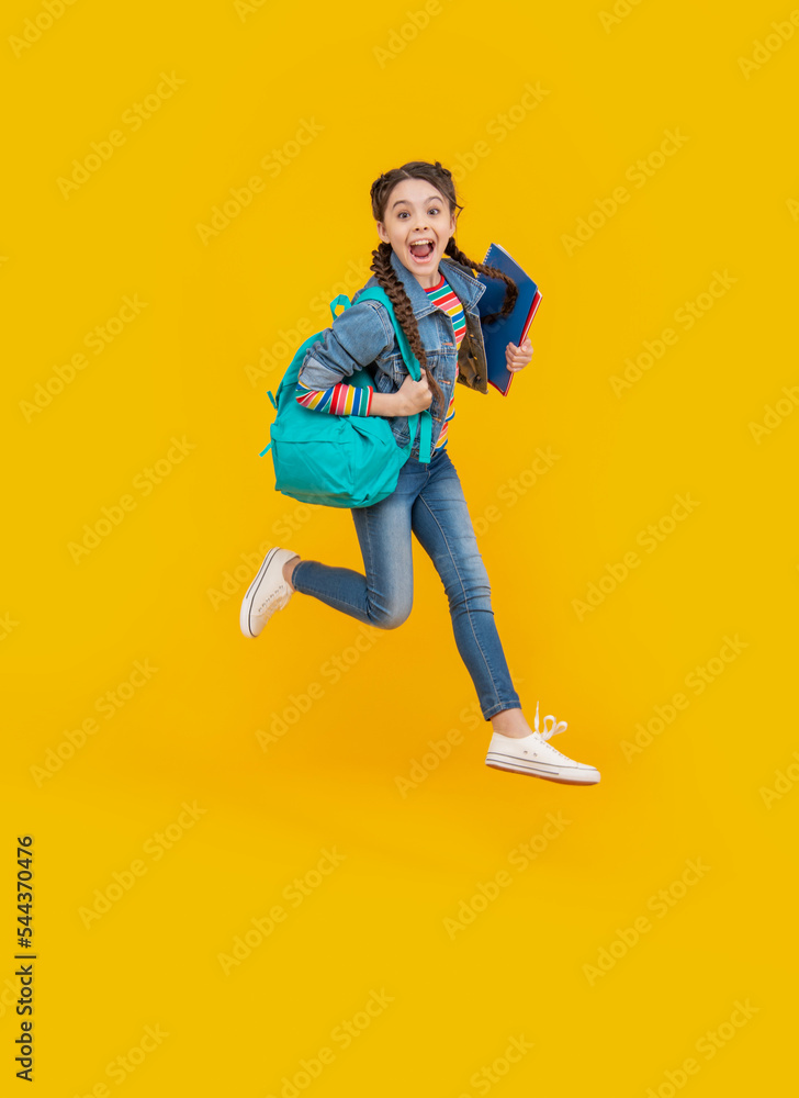 Energetic schoolgirl jumping, school. Excited teenage girl screaming in midair. School education