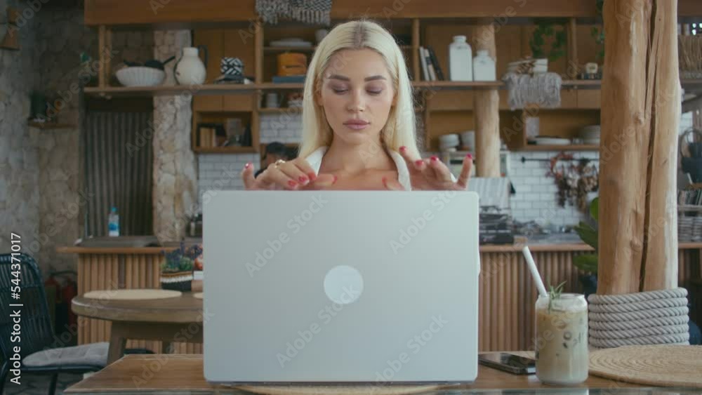 Beautiful Ukrainian blonde girl opening laptop computer. Pretty blonde woman starts working on notebook Beautiful Ukrainian blonde girl opening laptop computer. Pretty blonde woman starts working on notebook