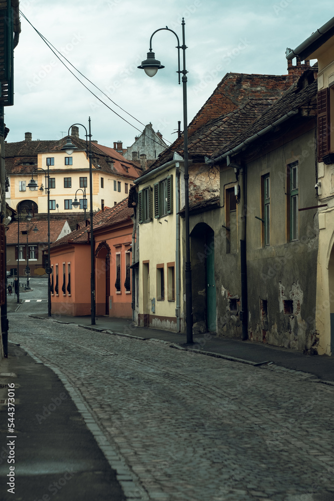 Medieval street and facade of historic buildings in city center of Sibiu Romania
