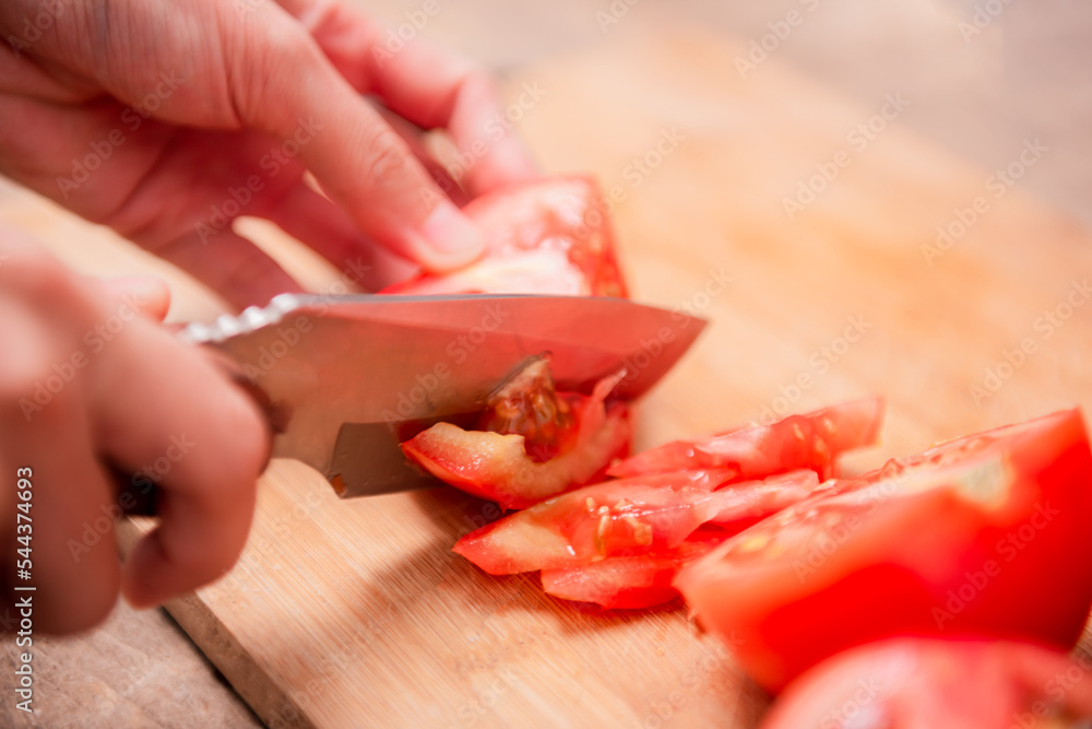 Preparing food, cutting tomatoes slices Preparing food, cutting tomatoes slices