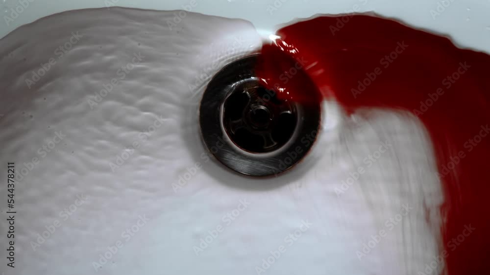 Closeup of Water Washing Dark Red Blood Into Sink Drain in Natural