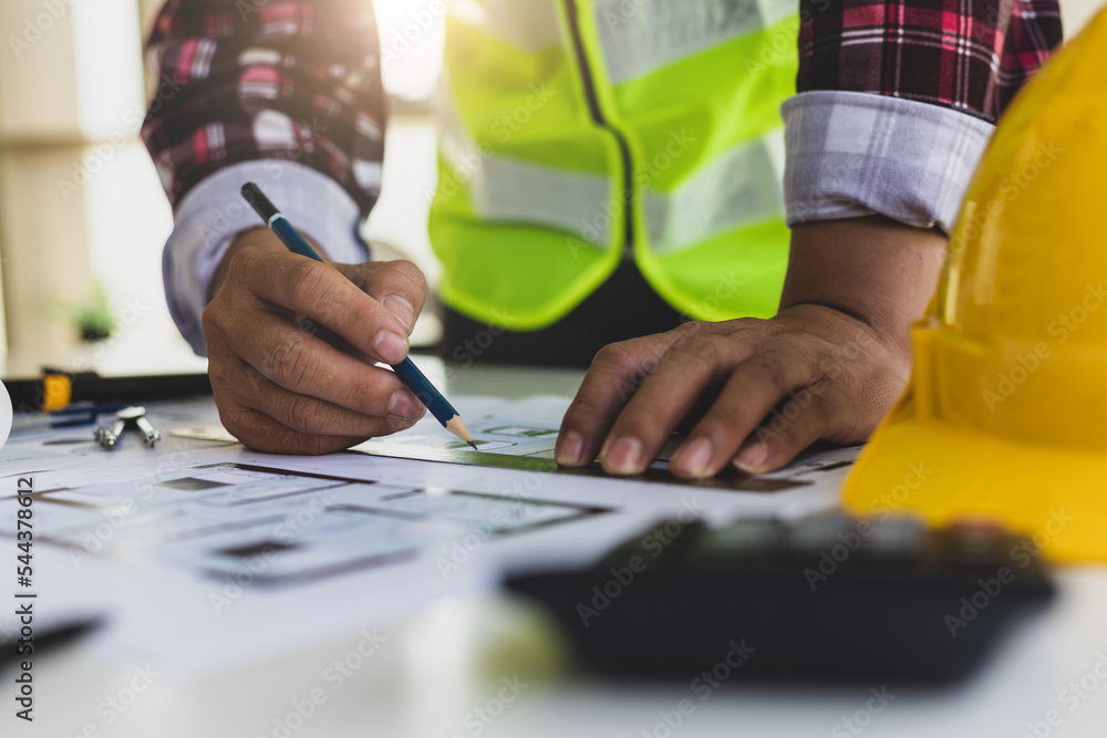 Architects in the design office are drawing blueprints and planning